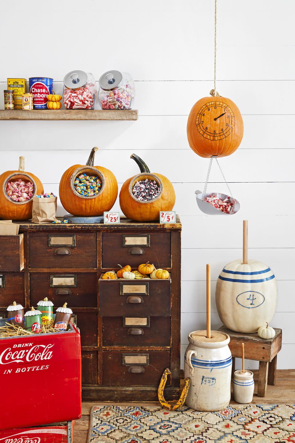 <p>Based on a ceramic butter churn, this pumpkin with add lots of country charm to your porch.<br><strong><br>Make the pumpkin: </strong>Remove the stem from a large white pumpkin.<br>Draw a vintage-looking number and an oval around it on the front of the pumpkin with a pencil. Attach blue twine over drawing with hot-glue. Create two stripes on the top of the pumpkin with blue<br>washi tape. Glue a 1" dowel where the stem was.<br></p>