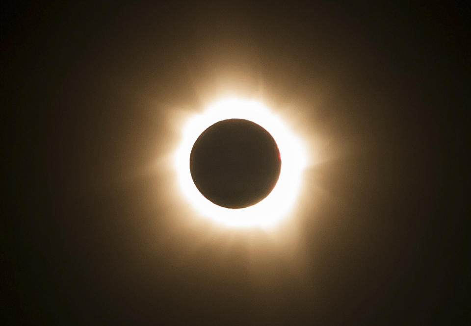 In this photo provided by Tourism Queensland, the moment of a total solar eclipse is observed at Cape Tribulation in Queensland state, Australia, Wednesday, Nov. 14, 2012. Starting just after dawn, the eclipse cast its 150-kilometer (95-mile) shadow in Australia's Northern Territory, crossed the northeast tip of the country and was swooping east across the South Pacific, where no islands are in its direct path. (AP Photo/Tourism Queensland) EDITORIAL USE ONLY