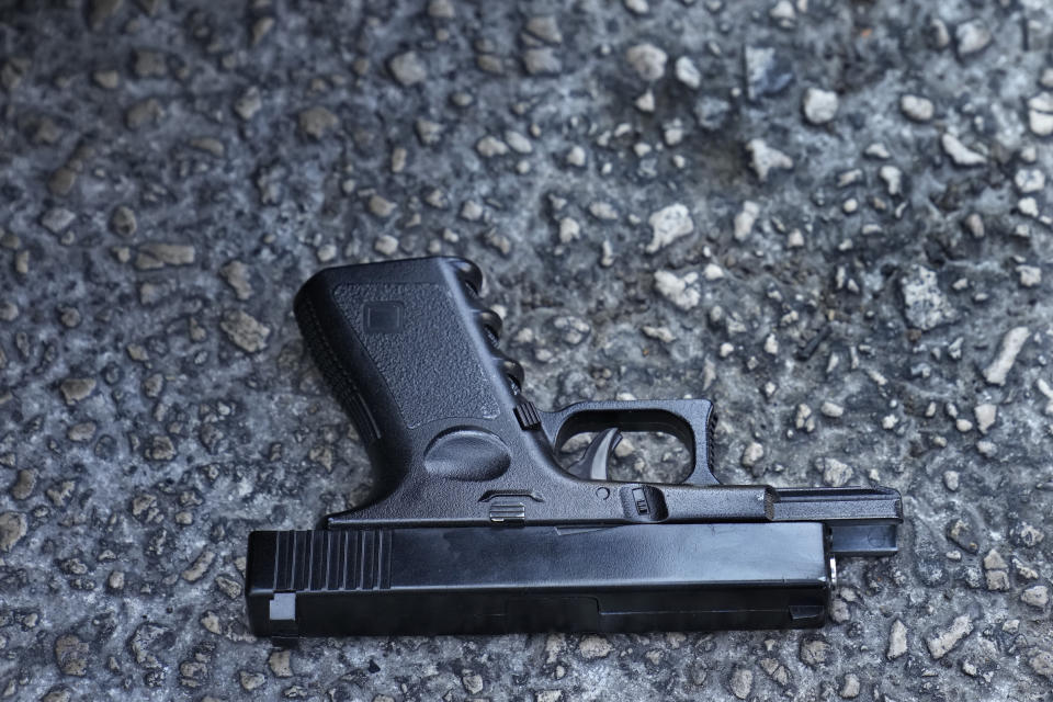 A toy pistol that was used by depositors to attack a bank is seen thrown on the ground, in Beirut, Lebanon, Wednesday, Sept. 14, 2022. An armed woman and a dozen activists broke into a Beirut bank branch on Wednesday, taking over $13,000 from what she says were from her trapped savings. Lebanon's cash-strapped banks since 2019 have imposed strict limits on withdrawals of foreign currency, tying up the savings of millions of people. (AP Photo/Hussein Malla)