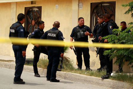 Police officers guard a crime scene where the bodies of several people were found inside a house, days before the visit of Mexico's President-Elect Andres Manuel Lopez Obrador, in Ciudad Juarez, Mexico August 3, 2018. REUTERS/Jose Luis Gonzalez