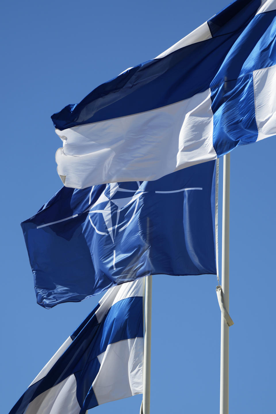 NATO and Finland flags flutter over the building of Ministry of Foreign Affairs in Helsinki, Finland, Tuesday, April 4, 2023. Finland prepared to make its historic entry into NATO Tuesday, a step that doubles the Western alliance’s border with Russia and ends decades of non-alignment for the Nordic nation. (AP Photo/Sergei Grits)