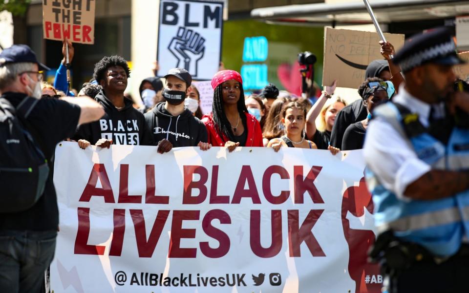 Demonstrators hold placards during a Black Lives Matter march on June 28, 2020 in London -  Hollie Adams/ Getty Images Europe