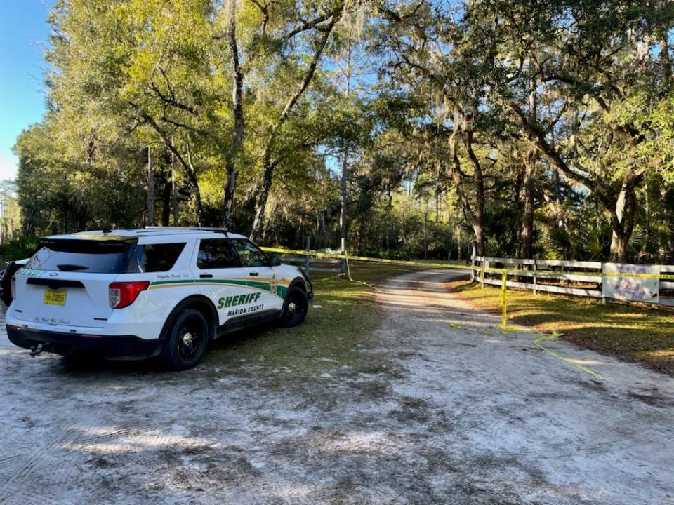 A Sheriff's Office cruiser parks at the scene of a deadly confrontation between deputies and an armed man on Monday night