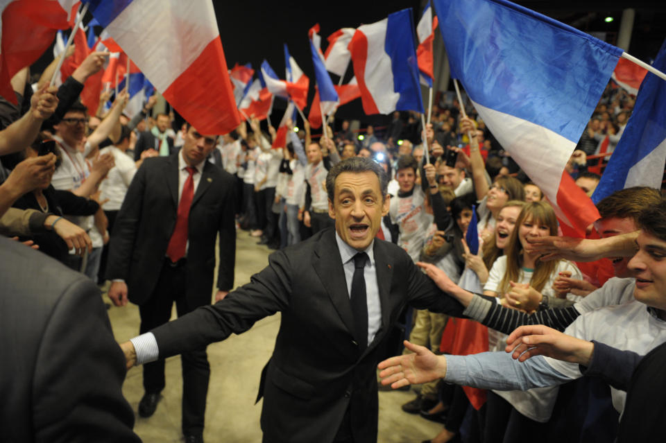 FILE - In this April 27, 2012 file photo, France's President and candidate for re-election in 2012, Nicolas Sarkozy, gestures as he delivers a speech in Dijon, central France. Former President Sarkozy is scheduled to go on trial Wednesday, March 17, on charges that his unsuccessful reelection bid in 2012 was illegally financed. (AP Photo/Philippe Wojazer, Pool, File)