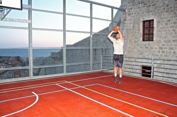 Justin Lee, cofounder of Baskets and Borders, is working with a small army of volunteers to restore the Sheldon Williams Collegiate basketball courts this summer. (Brendan Lee/submitted - image credit)