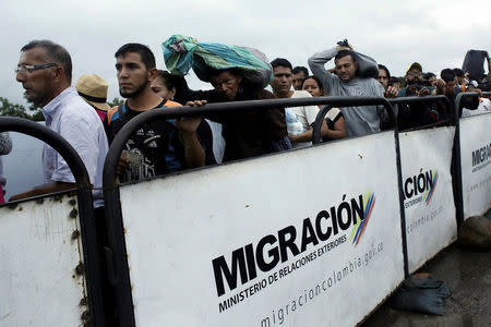 People queue to try to cross into Venezuela from Colombia through the Simon Bolivar international bridge in Cucuta, Colombia February 13, 2018. REUTERS/Carlos Eduardo Ramirez