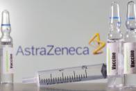 A test tube labelled with the Vaccine is seen in front of AstraZeneca logo in this illustration taken