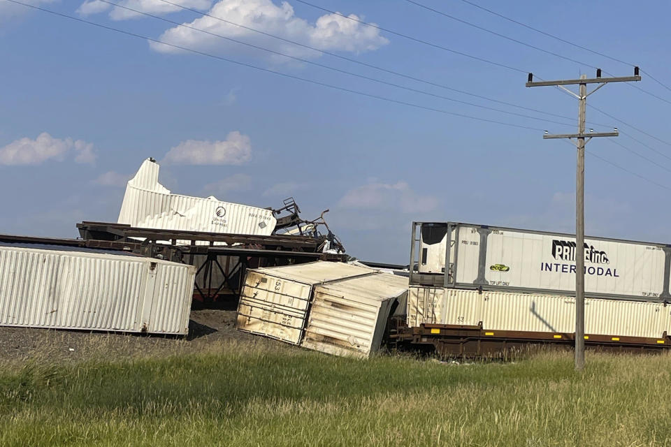 In this photo provided by Hill County Disaster and Emergency Services, freight cars from a BNSF Railway train are derailed east of Havre, Mont. on Friday, July 21, 2023. Local officials said 25 cars derailed but no one was injured. The cause is under investigation. (Amanda Frickel/Hill County Disaster and Emergency Services via AP)