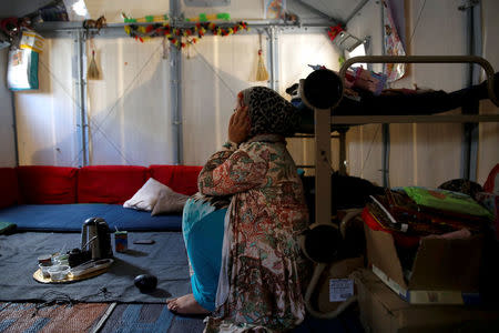 Syrian refugee Walaa, 26, sits inside her family's tent at the Souda municipality-run camp on the island of Chios, Greece, September 7, 2016. REUTERS/Alkis Konstantinidis/File Photo