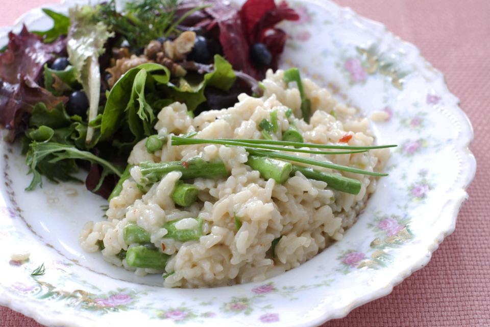 In this image taken on March 11, 2013, pressure cooker risotto with asparagus is shown served on a plate in Concord, N.H. (AP Photo/Matthew Mead)