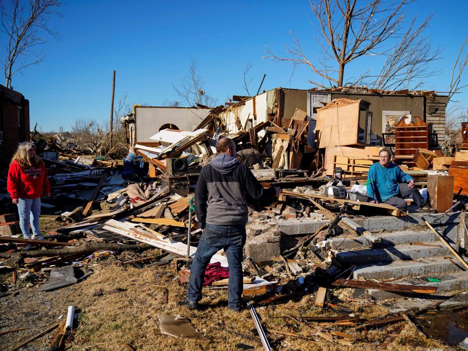 Rick Foley, 70, sits outside his home and speaks to neighbours after a devastating outbreak of tornadoes ripped through several U.S. states in Mayfield, Kentucky, U.S. December 11, 2021 (REUTERS)