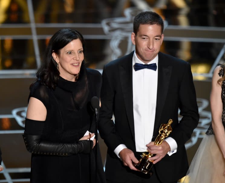 Laura Poitras, left, and Glenn Greenwald accept the award for best documentary feature for “Citizenfour” at the Oscars on Sunday, Feb. 22, 2015, at the Dolby Theatre in Los Angeles. (Photo: John Shearer/Invision/AP)