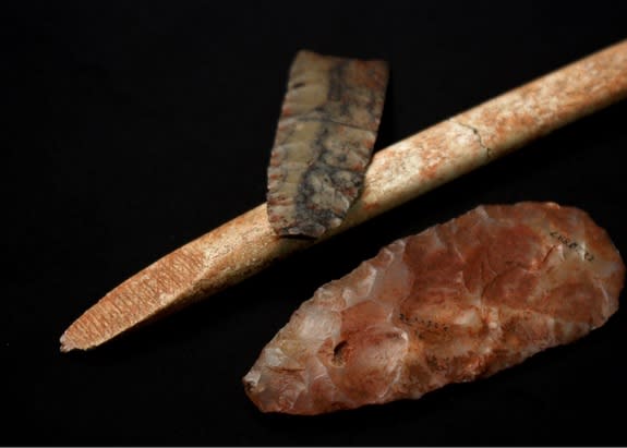 A nearly complete projectile point of dendritic chert, a mid-interval biface of translucent quartz, displaying relatively heavy red ochre residue and an "end-beveled" osseous rod, also exhibiting red ochre residue. These artifacts are technolog