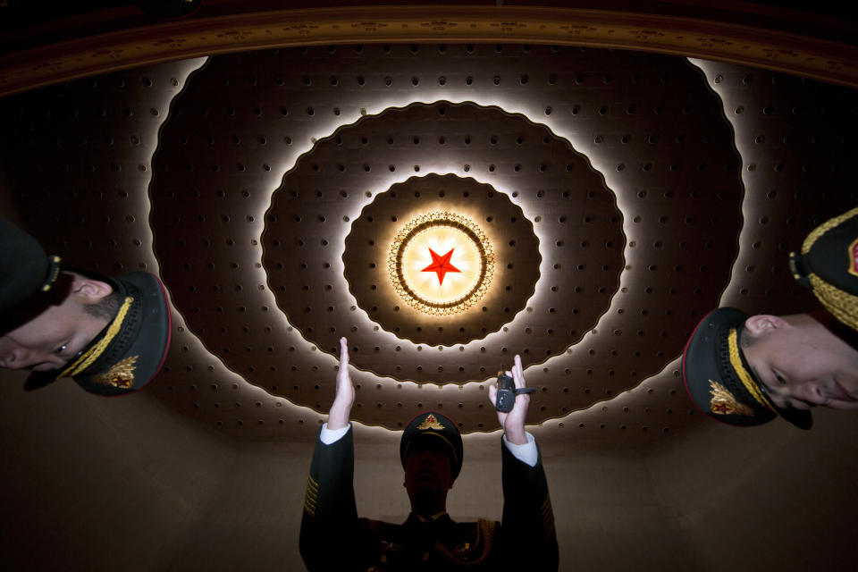 FILE- In this March 15, 2017, file photo, a military band conductor rehearses ahead of the closing session of the annual National People's Congress held in the Great Hall of the People in Beijing, China. Thousands of delegates from around China are gathering in Beijing for annual session of the country's rubber-stamp legislature and its advisory body, an event characterized more by the authoritarian ruling Communist Party leadership's desire to communicate its message than any actual discussion or passage of laws. (AP Photo/Ng Han Guan, File)