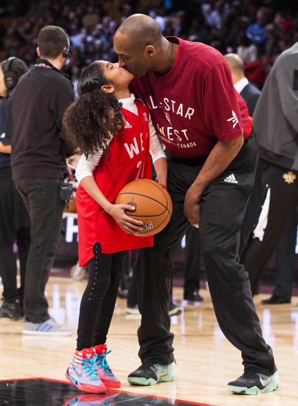 Kobe Bryant (24) kisses his daughter Gianna on the court in warm-ups before first half NBA All-Star Game basketball action in Toronto on Feb. 14 2016 (AP)