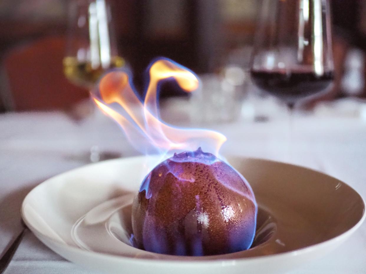 This chocolate sphere dessert, created by Cain for The Venetian Chop House, is lit on fire table-side using caramel liqueur. (Phoot: Lisa Wilk)      