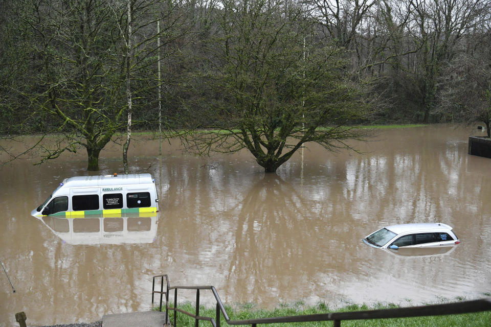 An ambulance, left, and a vehicle are submerged after flooding in Nantgarw, Wales, Sunday, Feb. 16, 2020. Storm Dennis roared across Britain on Sunday, lashing towns and cities with high winds and dumping so much rain that authorities urged residents to protect themselves from “life-threatening floods" in Wales and Scotland. (Ben Birchall/PA via AP)