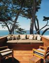 Off the meditation room, a roof deck doubles as a dining area; the built-in teak daybed has cushions and pillows of perennials outdoor fabric. (Photo: David Matheson)