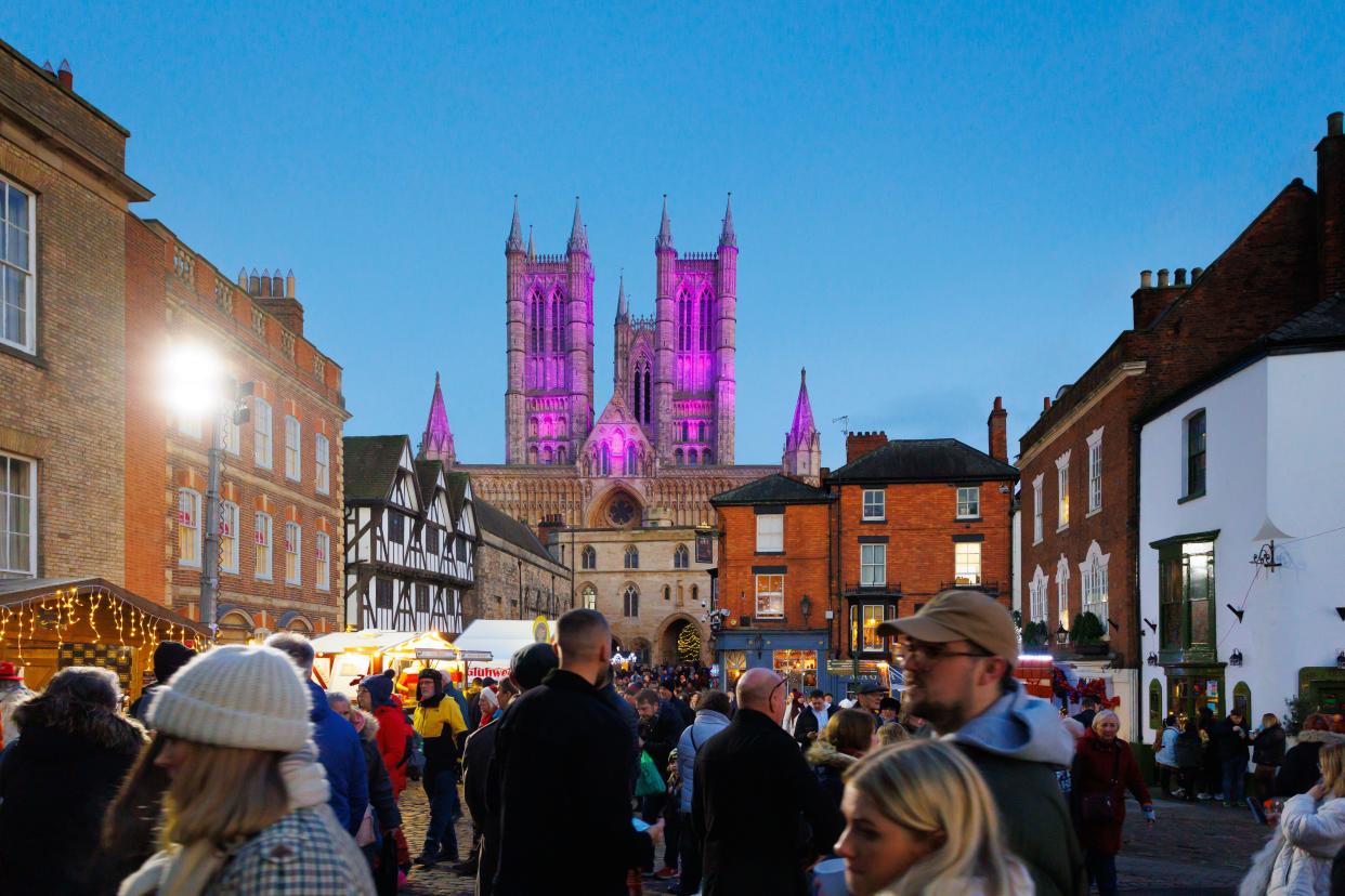 The annual Lincoln Christmas Market held every first weekend in December. The market is held in the uphill area of the City known as Bailgate, mainly around the Cathedral and the Castle. The cathedral if floodlit, in 2022 a blue/purple colour making it a centre piece seen acroos the City. Attracting thousands of people from all over Europe the market at times becomes a one way system to allow the large numbers of people to go around safely. Crowds infront of the floodlit Cathedral.