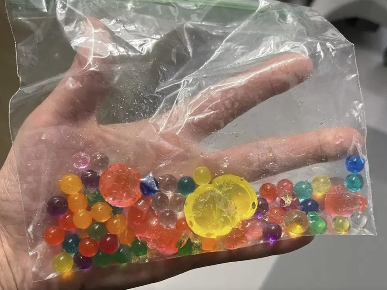 Folichia Mitchell holding a bag of the water beads