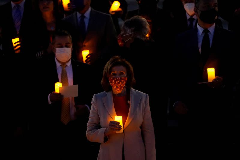 Bipartisan members of the House and Senate hold a moment of silence for the more than 800,000 American lives lost to COVID-19 outside the U.S. Capitol building in Washington