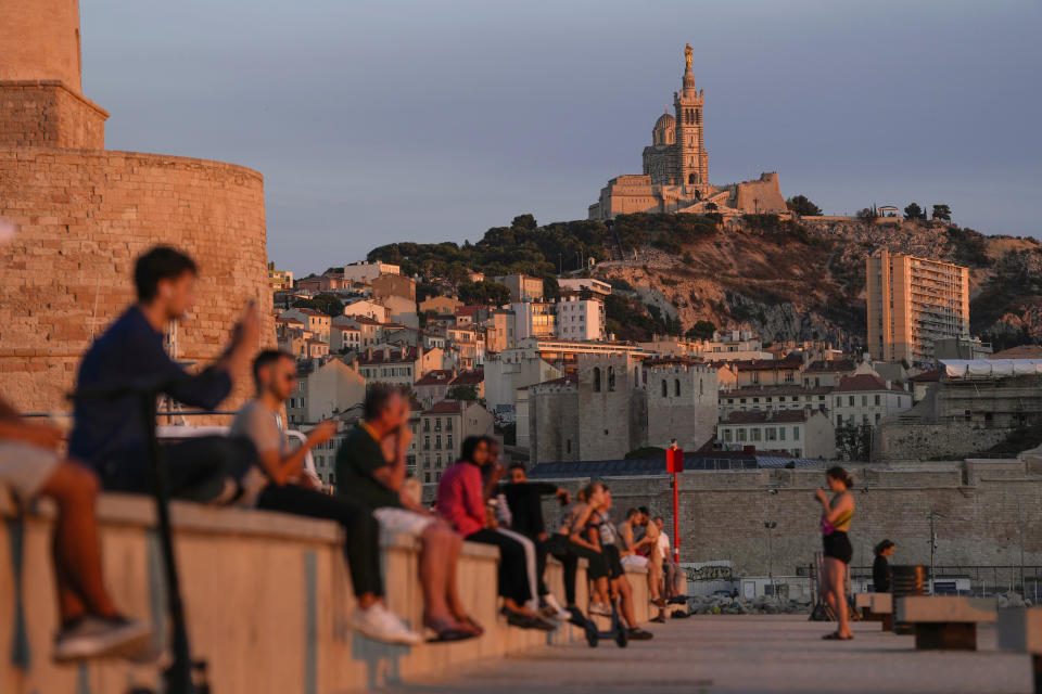 FILE - The Notre Dame de la Garde Basilica is seen on a top of the hill during a sunset in Marseille, France, Tuesday, Sept. 19, 2023. This word "Quoicoubeh!," became super popular this year with French teenagers who used it to annoy their elders and it doesn't have a real meaning. It's simple: A teen says something inaudible, hoping that parents or teachers will answer "Quoi?" or "What?" The response : "Quoicoubeh!" (AP Photo/Pavel Golovkin, File)