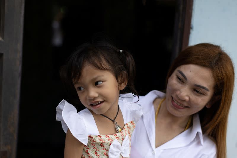 Panompai Sithong holds her daugther Paveenut Supolwong, the only child survivor of the mass shooting in Uthai Sawan