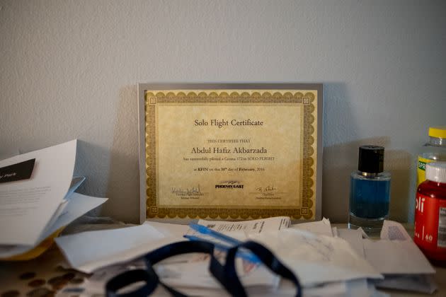 A flight certificate sits framed on Hafiz Akbarzada and his wife’s dresser in their new Colorado apartment on Sept. 12, 2022. (Photo: Eli Imadali for HuffPost)