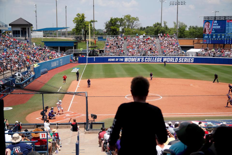 Fans watch a softball game between Utah and Washington in the Women's College World Series at USA Softball Hall of Fame Stadium in Oklahoma City, Friday, June 2, 2023. Washington won 4-1.