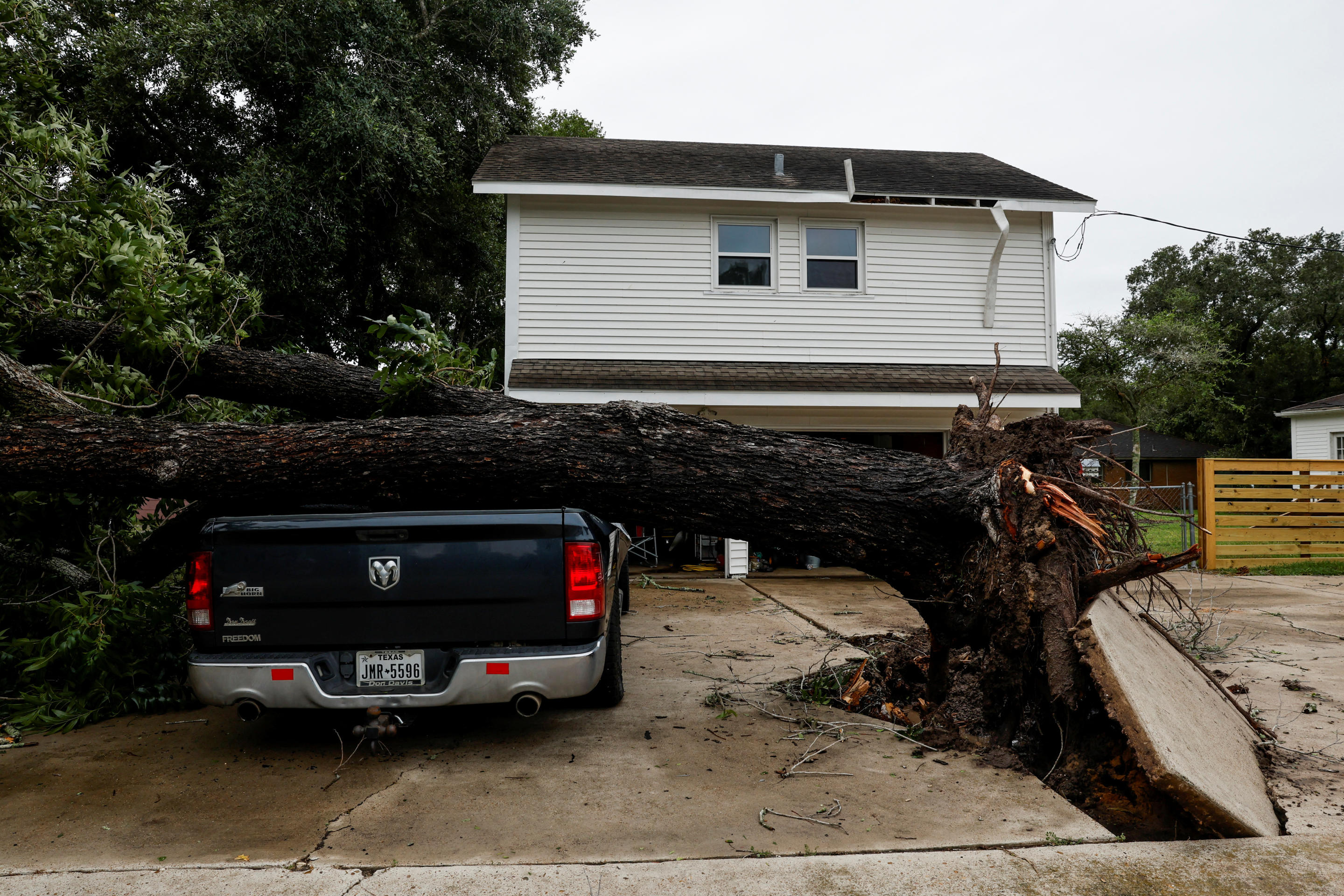 A fallen tree lies on a car in the aftermath of Hurricane Beryl in Ganado, Texas, on Monday. 