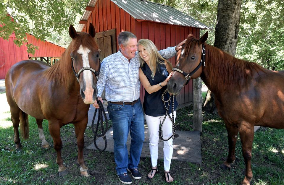 Former Sen. Bill Frist and his wife, Tracy Frist, pet their horses on their Old Town farm.