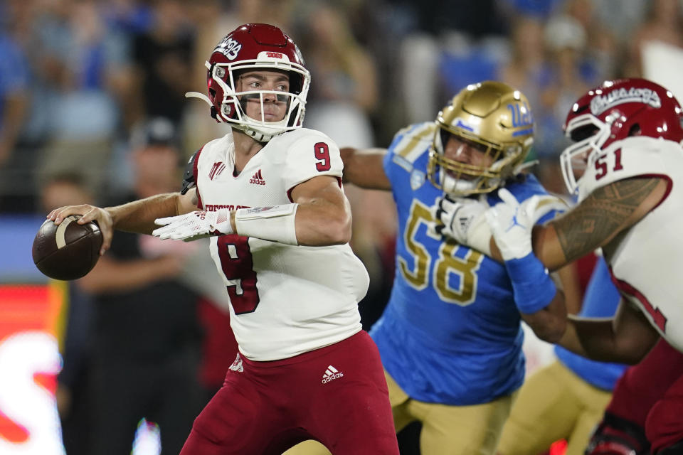 FILE - Fresno State quarterback Jake Haener looks for a receiver during the first half of the team's NCAA college football game against UCLA, Sept. 18, 2021, in Pasadena, Calif. Fresno State goes for the L.A. double over two seasons when it visits Lincoln Riley’s USC Trojans on Sept. 17, 2022. (AP Photo/Marcio Jose Sanchez, File)