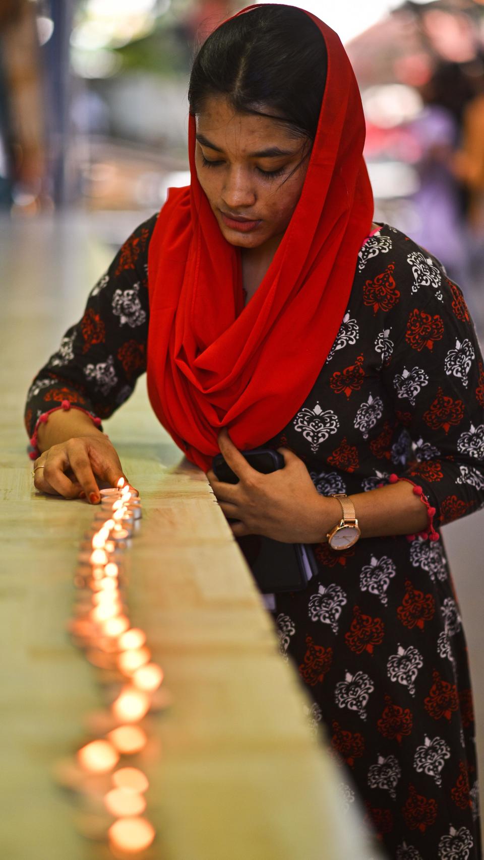 Una mujer coloca velas