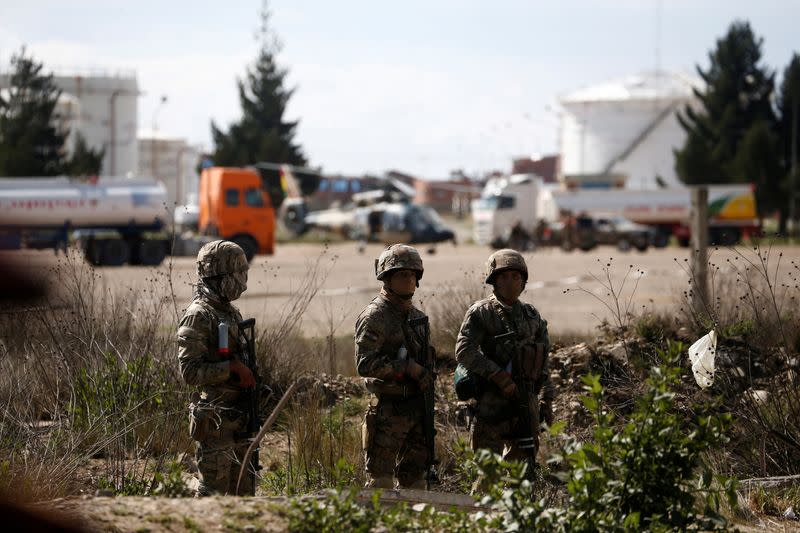 FILE PHOTO: Soldiers stand guard inside a power plant that supplies La Paz with gasoline, diesel and cooking gas, in Senkata