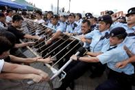 Activists fight to save the Queen's Pier in Hong Kong's financial district, August 1, 2007. ÊThe colonial-era pier in the city's financial heart became a civic battleground in 2007. The government wanted it removed for reclamation and roadworks, angering activists fighting to save what they viewed as a historic site. The saga reached boiling point in August when police forcibly evicted a band of activists and hunger strikers who had camped there for months. It was demolished in 2008. REUTERS/Paul Yeung/File photo