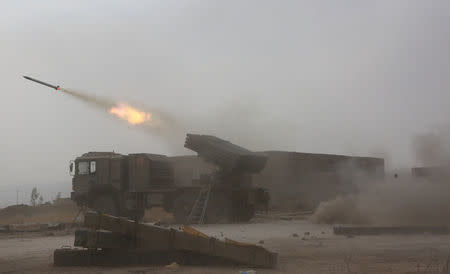 Popular Mobilization Forces (PMF) fire towards Islamic State militants during a battle on the outskirts of Al-Ba'aj, west of Mosul, Iraq May 26, 2017. Picture taken May 26, 2017. REUTERS/Stringer