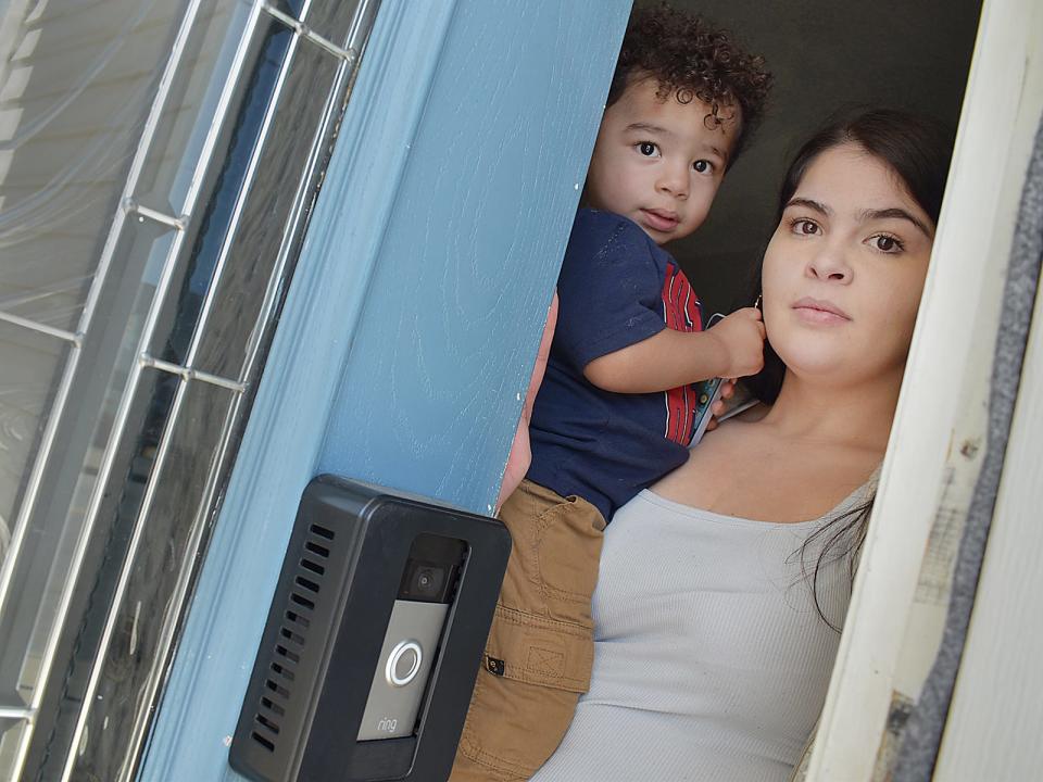 Linoshka Acevedo and her son, Leo in the doorway of their Fall River home.