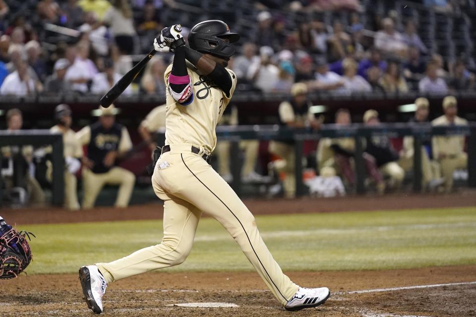 Arizona Diamondbacks' Geraldo Perdomo watches his two-run single against the Colorado Rockies during the eighth inning of a baseball game Friday, Aug. 5, 2022, in Phoenix. The Diamondbacks won 6-5. (AP Photo/Ross D. Franklin)