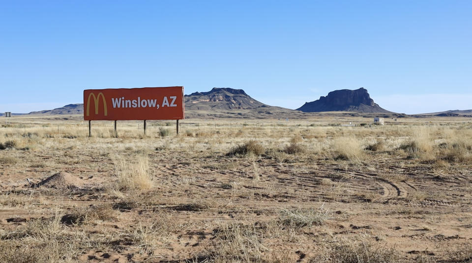 A billboard on the Navajo Nation near Leupp, Ariz., advertises fast food to passers-by in stark contrast to the majestic mesas that define the landscape. Despite the U.S. government systematically destroying traditional Navajo foodways, local chefs, grocers, farmers and entrepreneurs are working to create their own local food cooperative to bring healthy food to a community that suffers from high rates of diabetes and other food-related illnesses. (Chiara Sottile / NBC News)