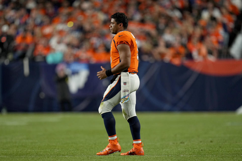 Denver Broncos quarterback Russell Wilson (3) walks out to greet teammates after a field goal during the second half of an NFL football game against the Indianapolis Colts, Thursday, Oct. 6, 2022, in Denver. (AP Photo/Jack Dempsey)