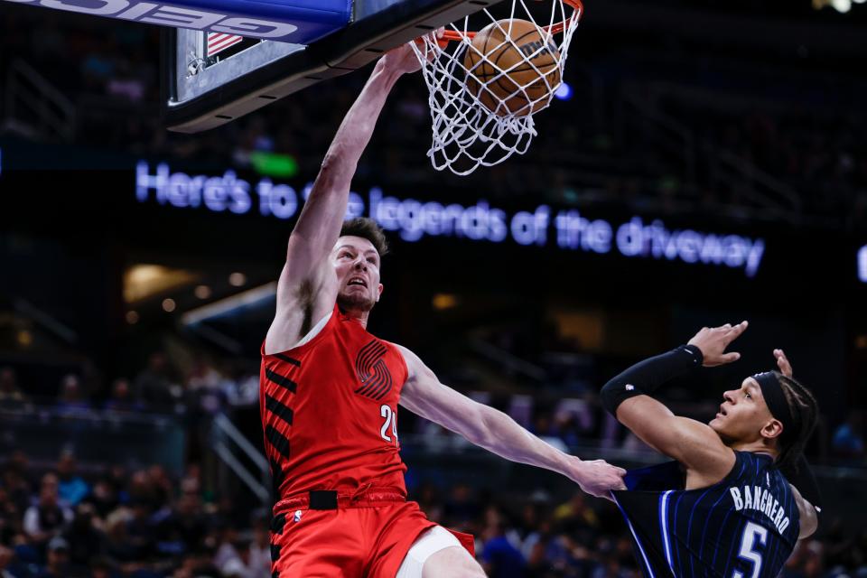 Portland Trail Blazers forward Drew Eubanks dunks the ball over Orlando Magic forward Paolo Banchero (5) during the first half of an NBA basketball game, Sunday, March 5, 2023, in Orlando, Fla. (AP Photo/Kevin Kolczynski)