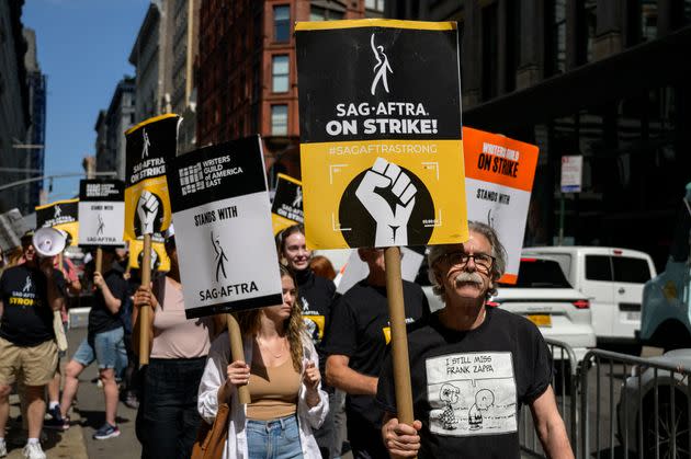 Members of the Writers Guild of America and the Screen Actors Guild - American Federation of Television and Radio Artists walk a picket line outside of Netflix and Warner Bros. Discovery in New York City on Wednesday. 