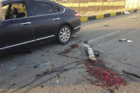 This photo released by the semi-official Fars News Agency shows the scene where Mohsen Fakhrizadeh was killed in Absard, a small city just east of the capital, Tehran, Iran, Friday, Nov. 27, 2020. Fakhrizadeh, an Iranian scientist that Israel alleged led the Islamic Republic's military nuclear program until its disbanding in the early 2000s was “assassinated” Friday, state television said. (Fars News Agency via AP)