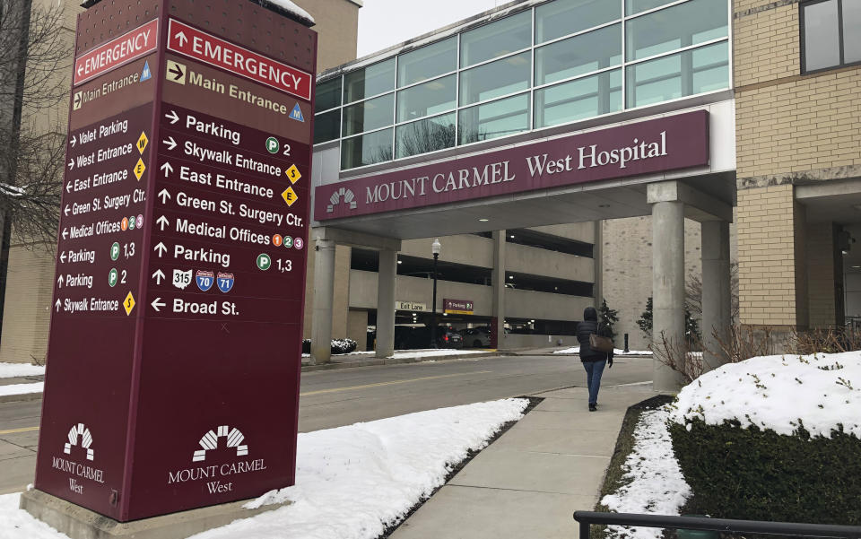 FILE - This Jan. 15, 2019 file photo shows the main entrance to Mount Carmel West Hospital in Columbus, Ohio. Mount Carmel Health System has reached nearly $4.5 million in settlements so far over the deaths of patients who allegedly received excessive painkiller doses ordered by a doctor now charged with murder. Over two dozen wrongful-death lawsuits have been filed against the Ohio hospital system and now-fired intensive care doctor William Husel. (AP Photo/Andrew Welsh Huggins, File)