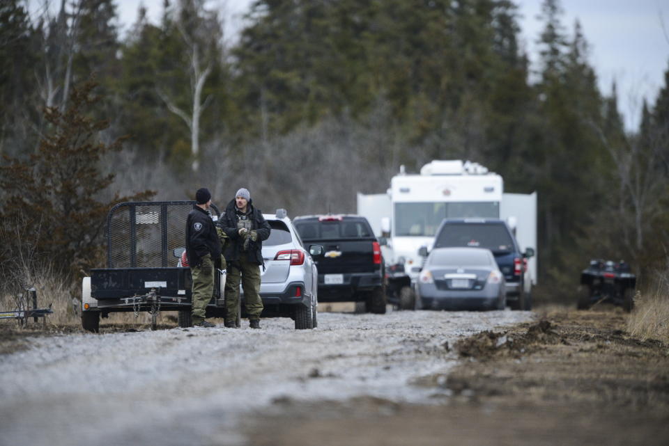 Personnel work at the site of a fatal plane crash in Kingston, Ontario, on Thursday, Nov. 28, 2019., as police and the Transportation Safety Board continue to investigate the incident. (Sean Kilpatrick/The Canadian Press via AP)