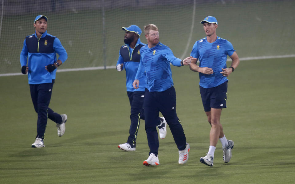 South Africa Twenty20 team's skipper Heinrich Klaasen, second right, with teammates warm up during a practice session for upcoming Twenty20 match against Pakistan, at the Gaddafi Stadium, in Lahore, Pakistan, Tuesday, Feb. 9, 2021. South Africa will play three Twenty20 matches against Pakistan, starting from Feb. 11. (AP Photo/K.M. Chaudary)