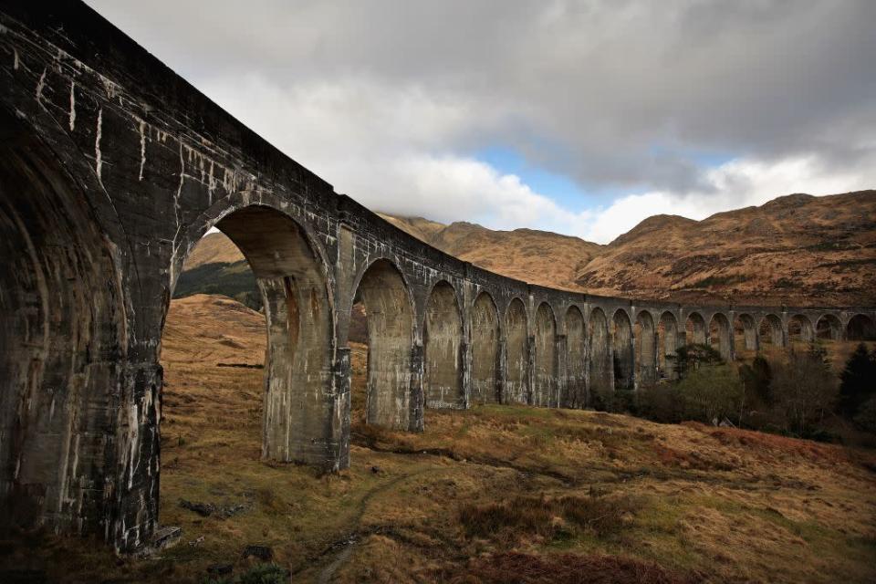 A view of the Glenfinnan Viaduct in Glenfinnan, Scotland. Built by Sir Robert McAlpine between 1897 and 1901, the single track viaduct that is made up of 21 arches is considered to have been one of the largest engineering projects of its time. Today, it is still used by ScotRail and was recently used for scenes in three of the Harry Potter films.