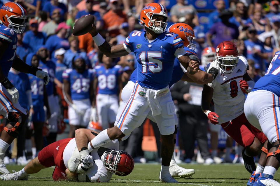 Florida quarterback Anthony Richardson (15) throws a pass for a completion while under pressure from Eastern Washington defensive lineman Brock Harrison during the first half of an NCAA college football game, Sunday, Oct. 2, 2022, in Gainesville, Fla. (AP Photo/Phelan M. Ebenhack)