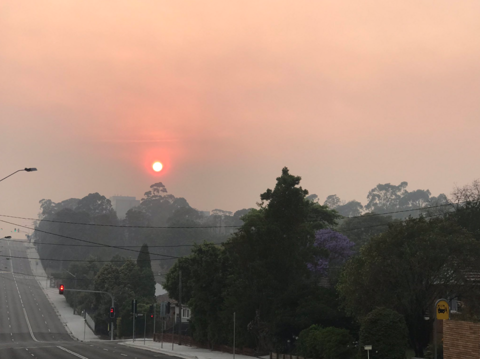 Smoke from bushfires in NSW created an orange sun across Sydney on Friday before a thunderstorm rolled in.