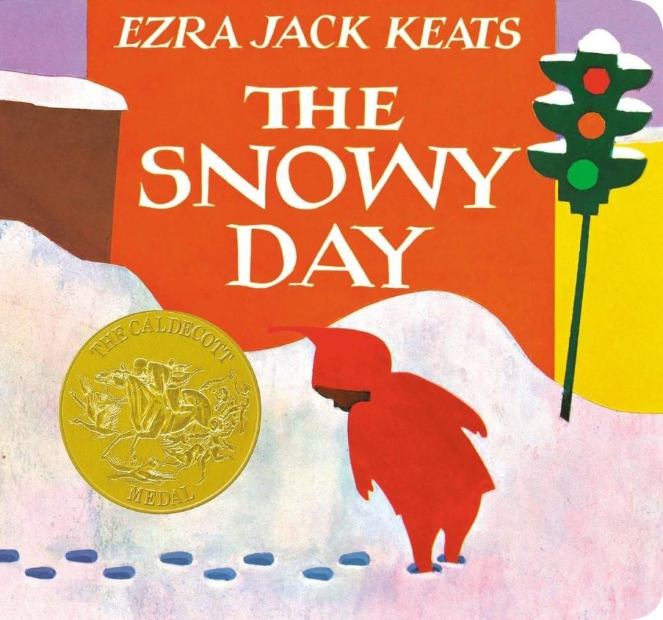 Book cover of "The Snowy Day" by Ezra Jack Keats showing a child in a red hooded coat with a Caldecott Medal